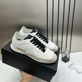 Chanel white calfskin and suede CC sneakers.