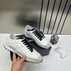 Chanel white calfskin and suede CC sneakers.