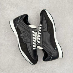 Chanel sneakers in black leather and suede with white laces.